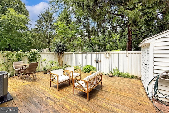 1581 Poplar Grove Dr, Reston, VA 20194 - wooden deck with a fenced backyard, outdoor dining space, and view of wooded area