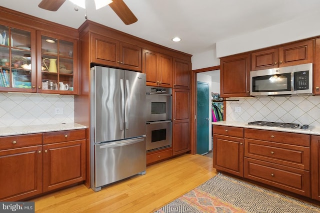11 Creek Rd, Southampton, PA 18966 - kitchen with appliances with stainless steel finishes, ceiling fan, light wood-style flooring, decorative backsplash, and recessed lighting