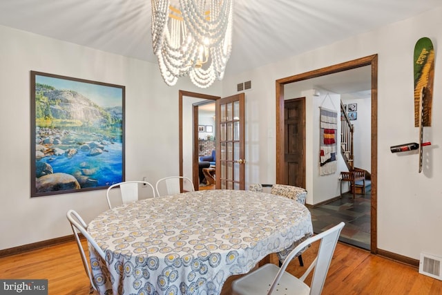 11 Creek Rd, Southampton, PA 18966 - dining space with light wood-type flooring, french doors, a chandelier, and stairs