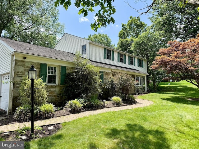 11 Creek Rd, Southampton, PA 18966 - view of front facade with stone siding, a front lawn, a shingled roof, and a garage
