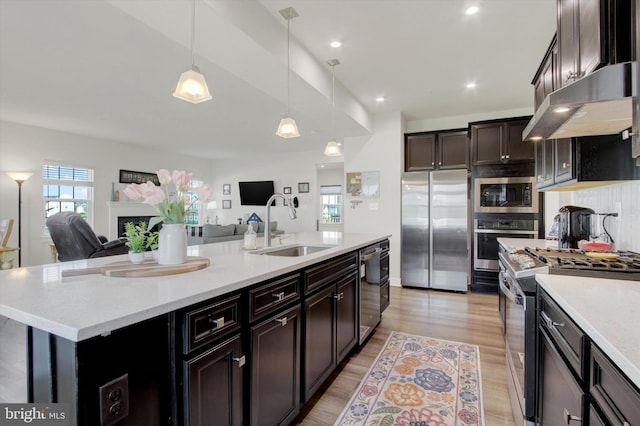 33 Winifred, Hanover, PA 17331 - kitchen with stainless steel appliances, under cabinet range hood, open floor plan, a center island with sink, and hanging light fixtures