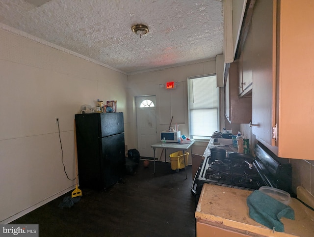 311 Calhoun St, Baltimore, MD 21223 - kitchen with black appliances, light countertops, and dark wood-style flooring