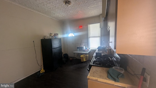 311 Calhoun St, Baltimore, MD 21223 - kitchen featuring freestanding refrigerator, light countertops, and a textured ceiling