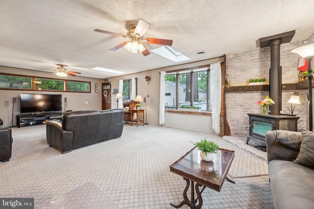 1318 Morgan Ave, Cinnaminson, NJ 08077 - carpeted living area with a wood stove, a ceiling fan, a skylight, and a textured ceiling