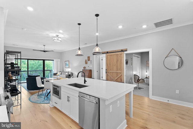 44691 Wellfleet Dr Unit 306, Ashburn, VA 20147 - kitchen featuring stainless steel dishwasher, a barn door, open floor plan, white cabinets, and crown molding