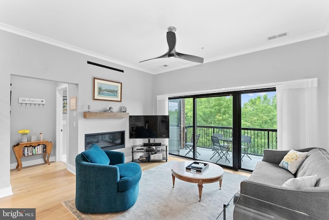 44691 Wellfleet Dr Unit 306, Ashburn, VA 20147 - living room featuring crown molding, a glass covered fireplace, wood finished floors, and a ceiling fan