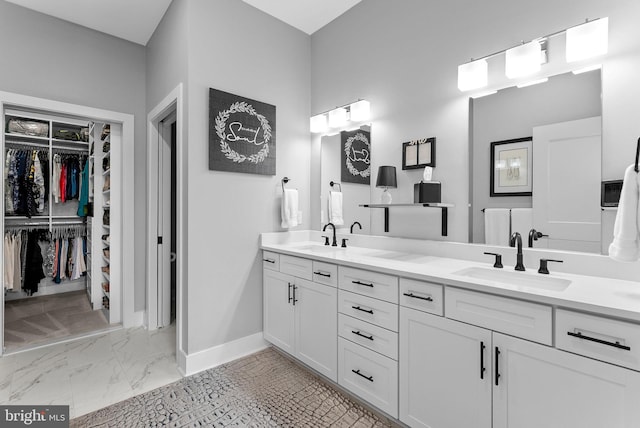 44691 Wellfleet Dr Unit 306, Ashburn, VA 20147 - full bathroom featuring double vanity, marble finish floors, and a spacious closet