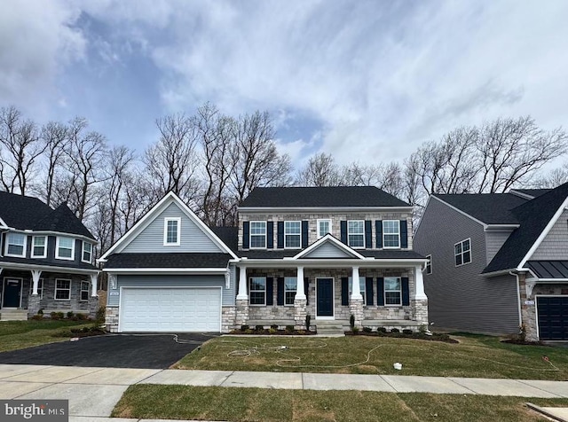 1823 Colt Ln, Frederick, MD 21702 - view of front of property featuring stone siding, a garage, asphalt driveway, a porch, and a front yard