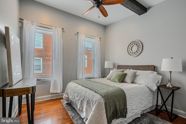 12 S Castle St, Baltimore, MD 21231 - bedroom featuring multiple windows, wood-type flooring, beam ceiling, and a ceiling fan