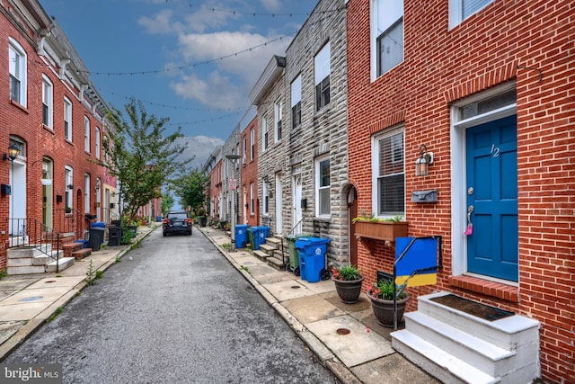 12 S Castle St, Baltimore, MD 21231 - view of asphalt alley featuring entry steps, a residential view, and curbs