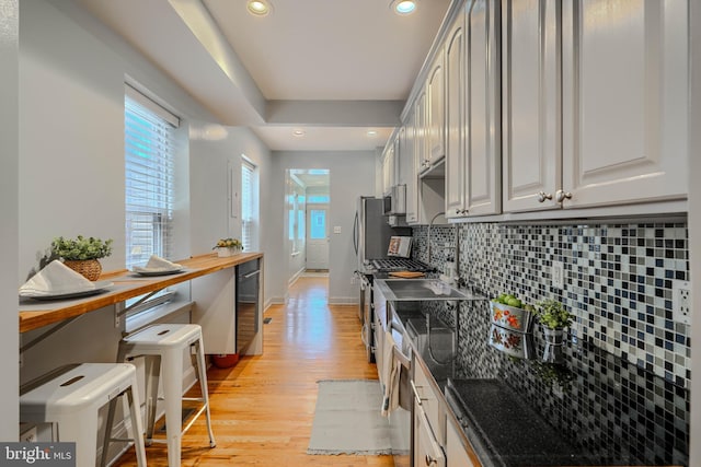 12 S Castle St, Baltimore, MD 21231 - kitchen with light wood-style floors, backsplash, recessed lighting, butcher block countertops, and beverage cooler