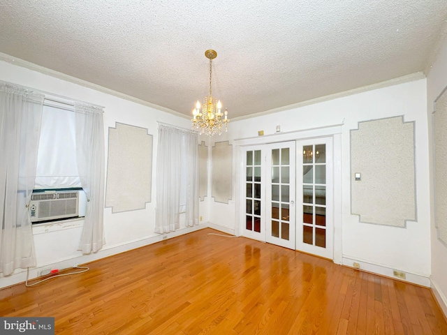2636 Rhode Island Ave NE, Washington, DC 20018 - unfurnished dining area with french doors, cooling unit, wood finished floors, a chandelier, and a textured ceiling