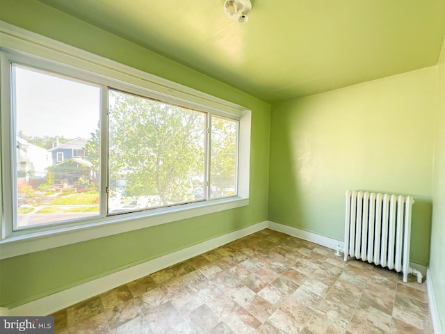2636 Rhode Island Ave NE, Washington, DC 20018 - spare room featuring radiator heating unit and stone finish floors