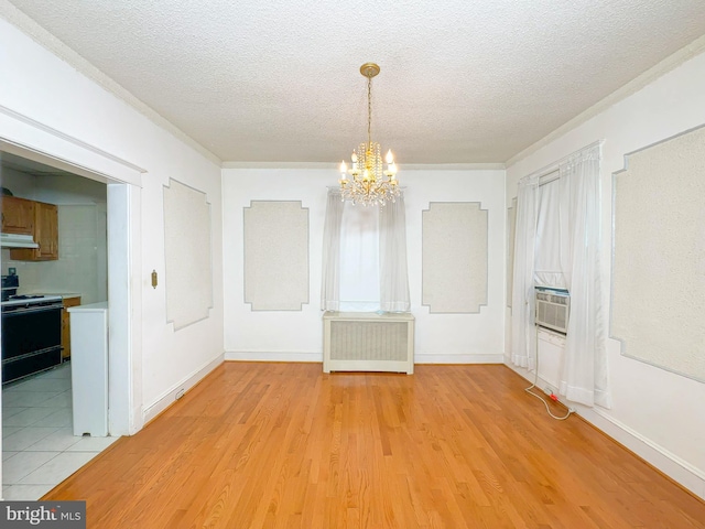 2636 Rhode Island Ave NE, Washington, DC 20018 - unfurnished dining area with radiator, a chandelier, a textured ceiling, light wood-style floors, and crown molding
