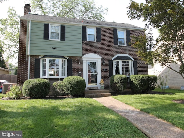 243 Pinehurst Rd, Wilmington, DE 19803 - view of front facade featuring brick siding, a chimney, and a front lawn