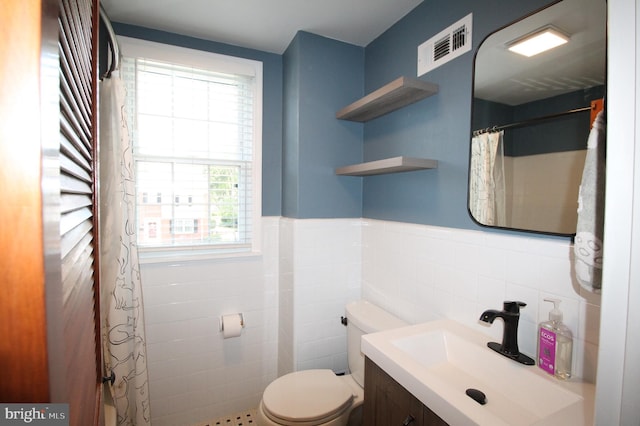 243 Pinehurst Rd, Wilmington, DE 19803 - full bathroom featuring tile walls, vanity, wainscoting, and a shower with shower curtain