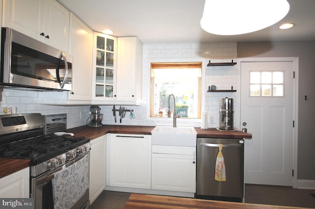 243 Pinehurst Rd, Wilmington, DE 19803 - kitchen featuring stainless steel appliances, butcher block counters, plenty of natural light, backsplash, and recessed lighting