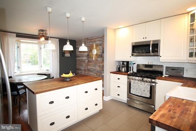243 Pinehurst Rd, Wilmington, DE 19803 - kitchen featuring wood counters, stainless steel appliances, glass insert cabinets, and decorative light fixtures