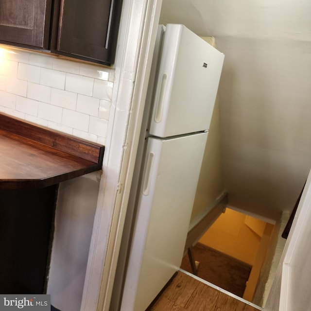 175 Stoneway Ln, Bala Cynwyd, PA 19004 - kitchen with dark brown cabinets, tasteful backsplash, wood finished floors, freestanding refrigerator, and wooden counters