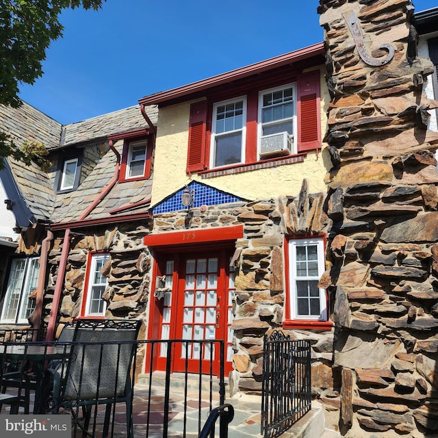 175 Stoneway Ln, Bala Cynwyd, PA 19004 - view of property with stone siding, a high end roof, and a gate