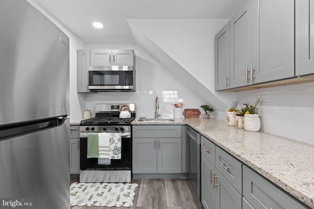 1072 Lakeshore Dr, Camden, NJ 08104 - kitchen featuring stainless steel appliances, gray cabinetry, backsplash, light stone counters, and recessed lighting