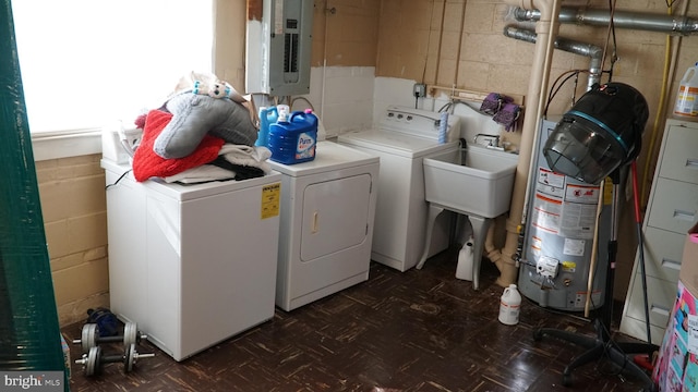 812 Byram St, Reading, PA 19606 - washroom with separate washer and dryer, electric panel, water heater, concrete block wall, and dark flooring