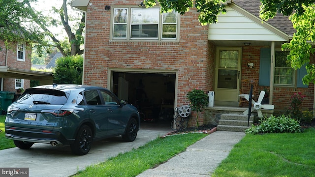 812 Byram St, Reading, PA 19606 - view of front of house featuring driveway, brick siding, and a garage