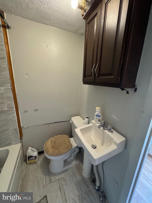 226 E Snyder Ave, Lansford, PA 18232 - full bathroom with a textured ceiling and a tub to relax in