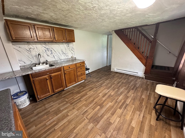 226 E Snyder Ave, Lansford, PA 18232 - bar featuring baseboard heating, stairway, wood finished floors, and decorative backsplash