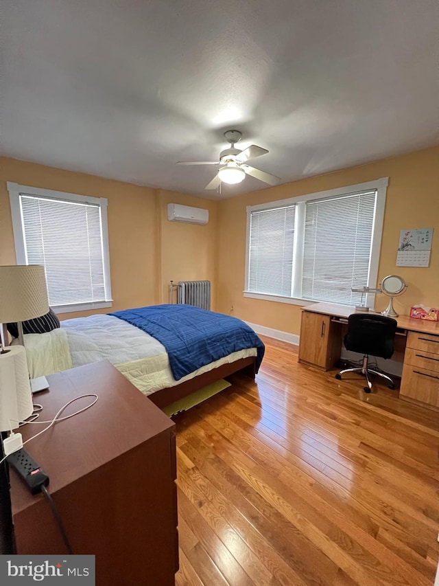 7033 Gillespie St, Philadelphia, PA 19135 - bedroom with a wall mounted air conditioner, light wood finished floors, a desk, radiator, and a ceiling fan