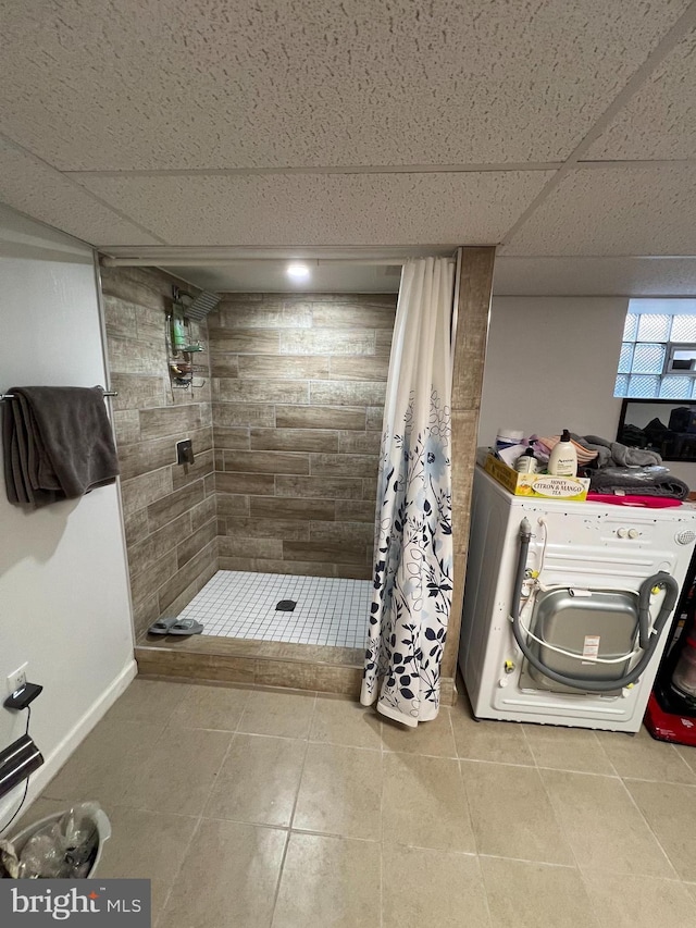 7033 Gillespie St, Philadelphia, PA 19135 - bathroom featuring a stall shower, washer / clothes dryer, a paneled ceiling, and tile patterned floors