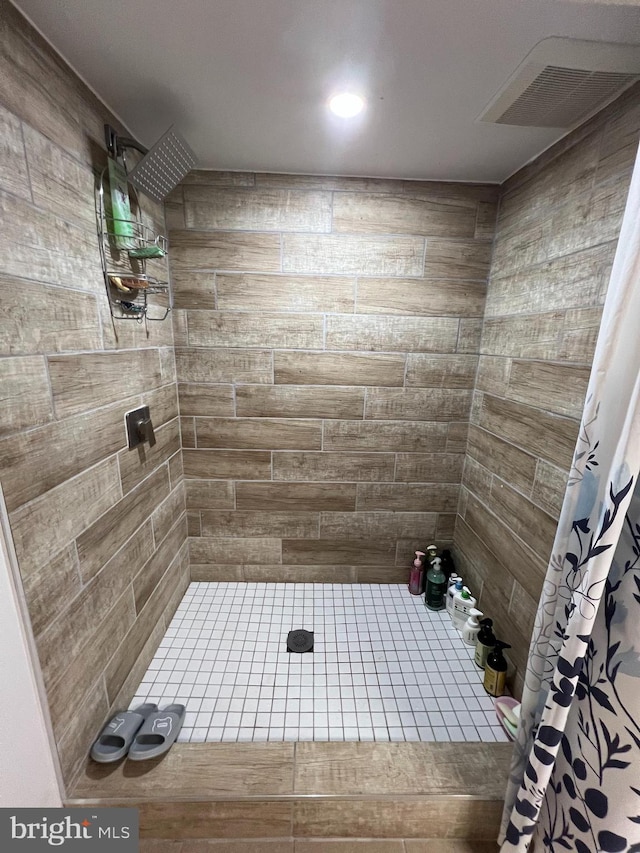 7033 Gillespie St, Philadelphia, PA 19135 - bathroom featuring a tile shower and tile patterned floors