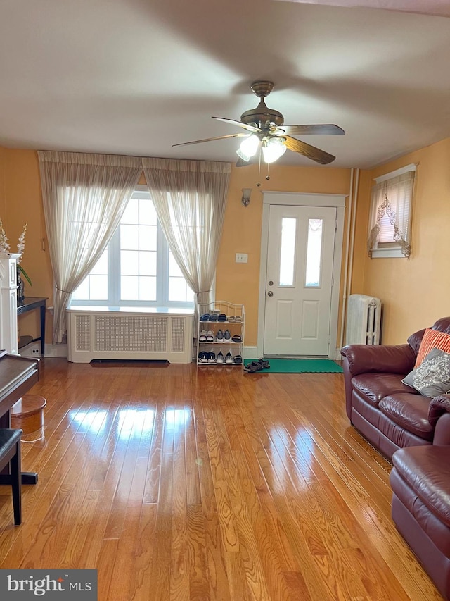 7033 Gillespie St, Philadelphia, PA 19135 - living room with radiator heating unit, hardwood / wood-style floors, and ceiling fan