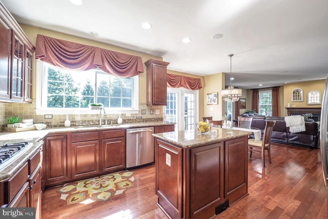 1901 Eamons Way, Annapolis, MD 21401 - kitchen with stainless steel appliances, hardwood / wood-style flooring, tasteful backsplash, light stone counters, and a center island