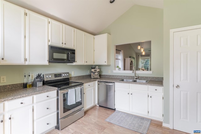 1470 Willow Lake Dr, Charlottesville, VA 22902 - kitchen with stainless steel appliances, vaulted ceiling, white cabinets, and light wood-type flooring