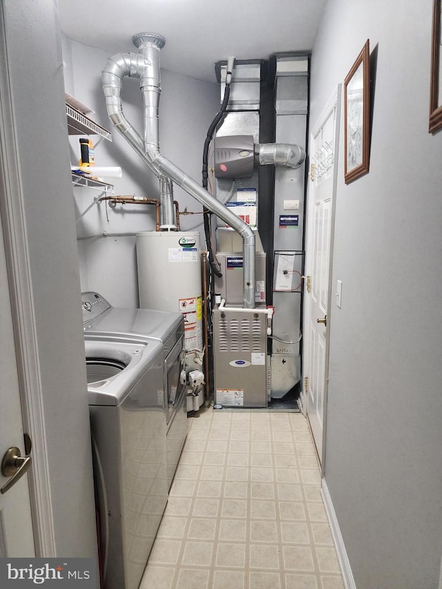 33 Sunset Ln, Columbus, NJ 08022 - laundry area featuring washing machine and clothes dryer, water heater, and light floors