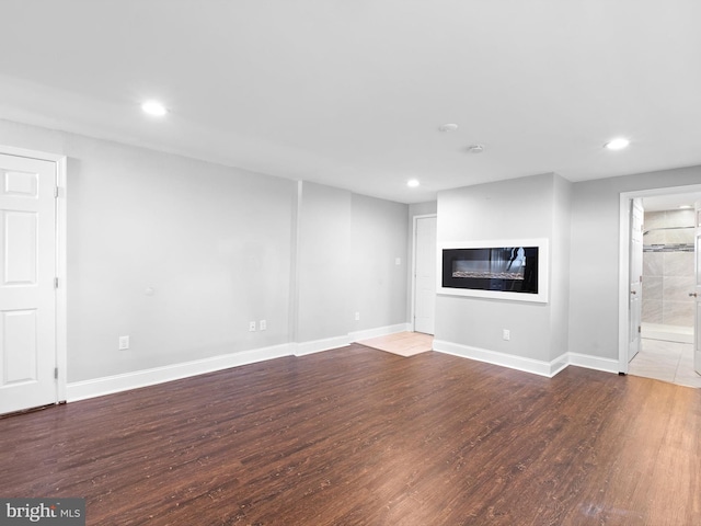 4 Paisley Dr, Wilmington, DE 19808 - unfurnished living room with wood finished floors, a glass covered fireplace, and recessed lighting