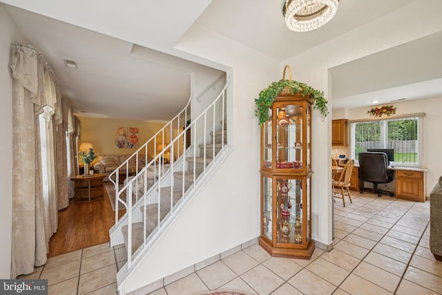 81 Argyle Ave, Blackwood, NJ 08012 - staircase featuring tile patterned floors and a chandelier