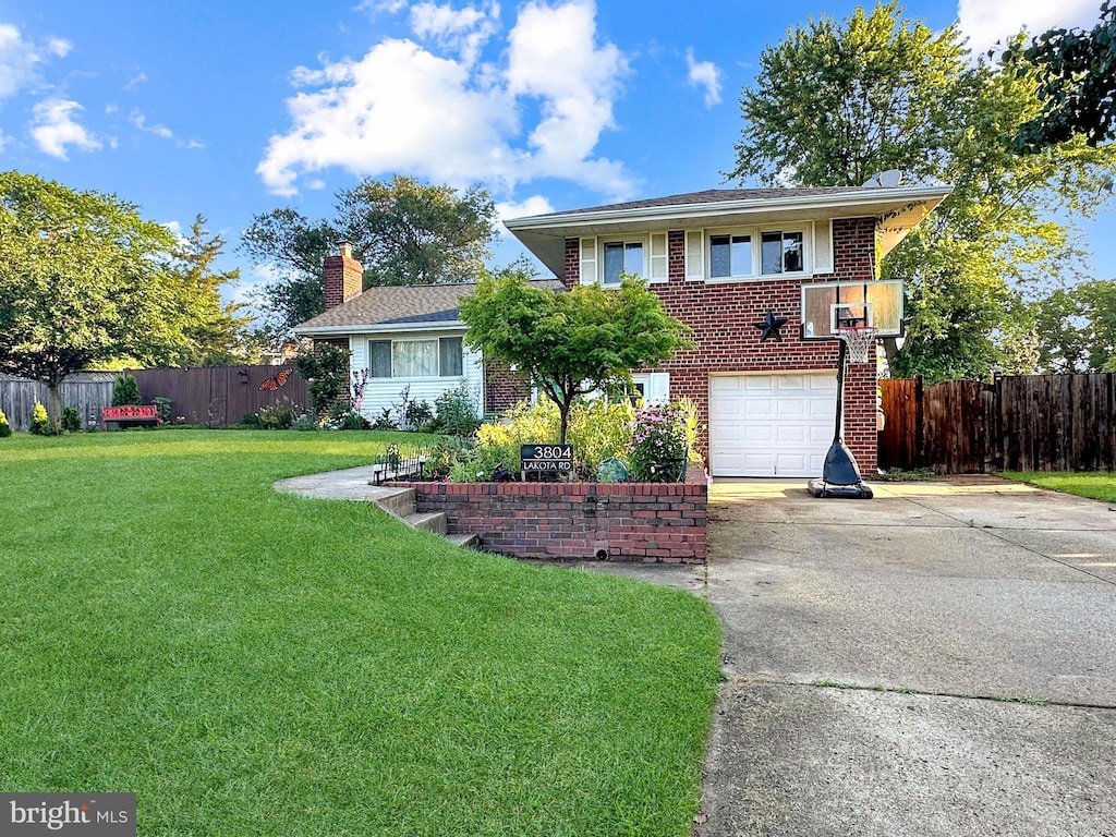 3804 Lakota Rd, Alexandria, VA 22303 - view of front facade with driveway, brick siding, an attached garage, and a chimney