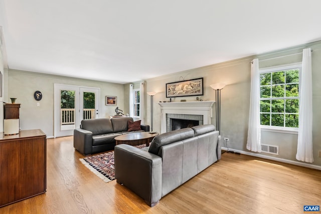 2402 Bennington Rd, Charlottesville, VA 22901 - living area with light wood-style floors, a fireplace, and ornamental molding