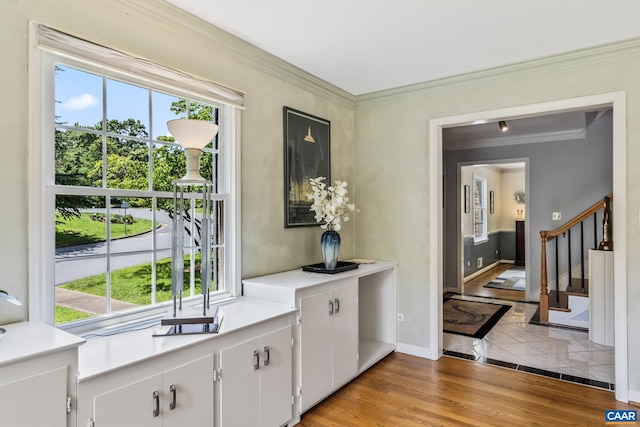 2402 Bennington Rd, Charlottesville, VA 22901 - interior space featuring healthy amount of natural light, crown molding, light countertops, white cabinetry, and light wood-style floors