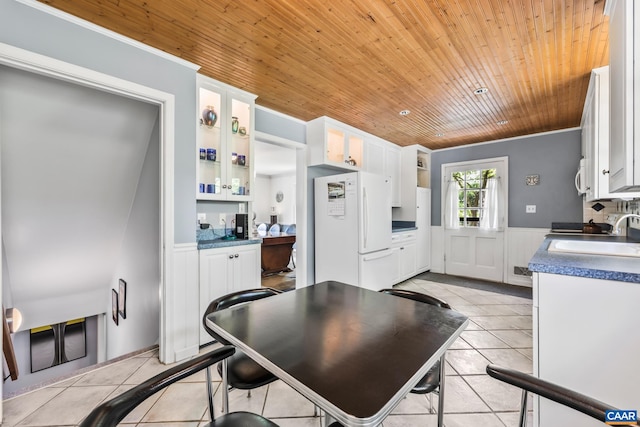 2402 Bennington Rd, Charlottesville, VA 22901 - kitchen with white appliances, wood ceiling, white cabinets, light tile patterned floors, and wainscoting