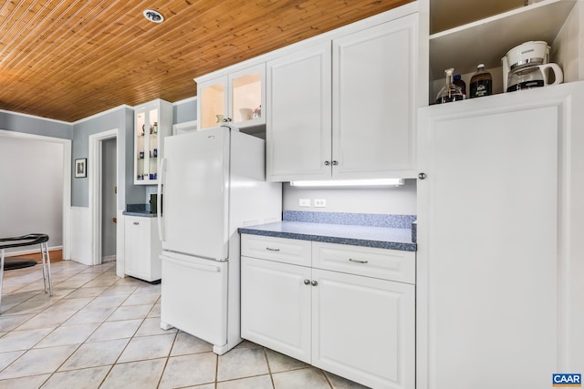 2402 Bennington Rd, Charlottesville, VA 22901 - kitchen featuring freestanding refrigerator, wooden ceiling, dark countertops, light tile patterned floors, and glass insert cabinets