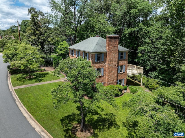 2402 Bennington Rd, Charlottesville, VA 22901 - view of side of home featuring a chimney, brick siding, a wooden deck, and a yard