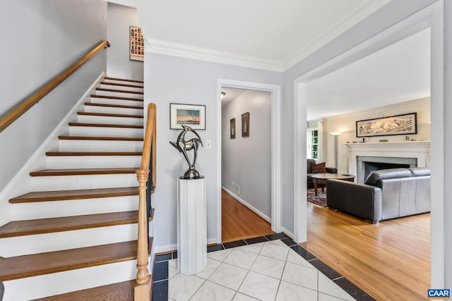 2402 Bennington Rd, Charlottesville, VA 22901 - stairway with crown molding, a fireplace, and wood finished floors
