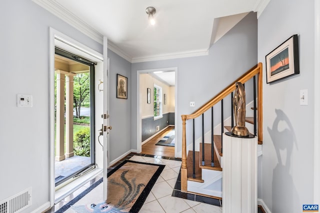 2402 Bennington Rd, Charlottesville, VA 22901 - tiled entryway with inlaid floor details, crown molding, stairs, and decorative columns