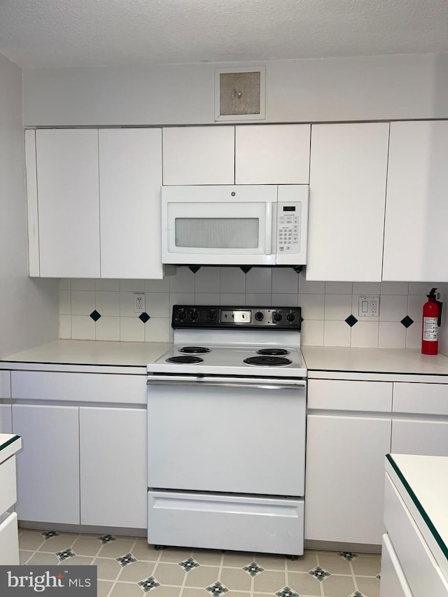 1420 Locust St Unit 20Q, Philadelphia, PA 19102 - kitchen with white appliances, light countertops, and white cabinets
