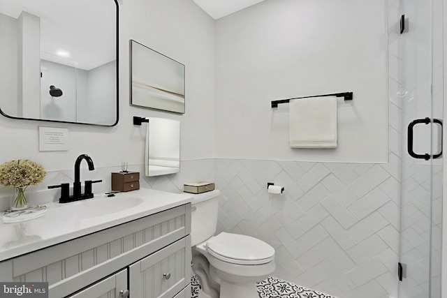 1133 46th St SE, Washington, DC 20019 - full bath with tile walls, a shower stall, vanity, and a wainscoted wall