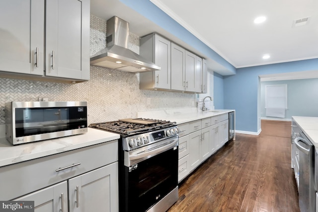 1133 46th St SE, Washington, DC 20019 - kitchen with appliances with stainless steel finishes, wall chimney exhaust hood, backsplash, beverage cooler, and crown molding