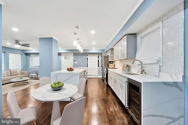 1133 46th St SE, Washington, DC 20019 - dining space featuring beverage cooler, dark wood-style floors, ceiling fan, and recessed lighting
